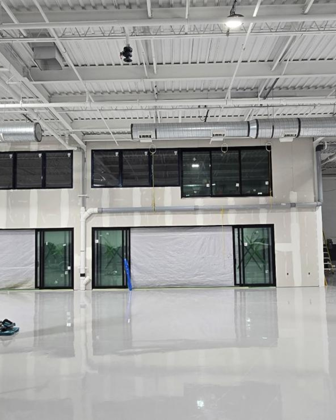 Multi-panel stacking sliding door system for open-concept commercial space.