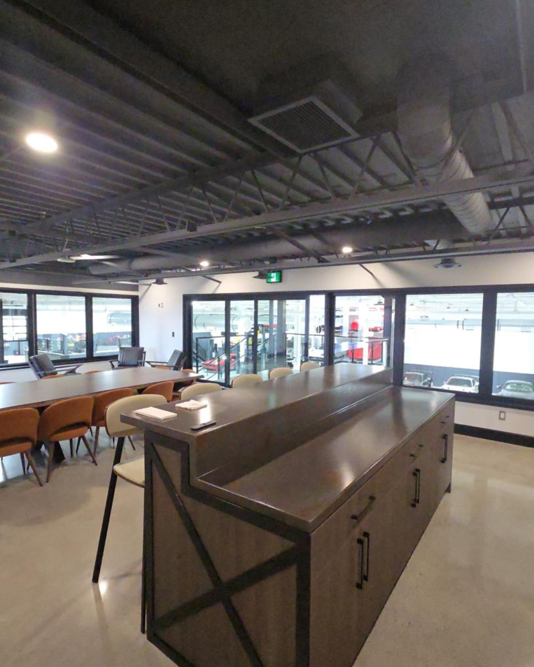 Modern office interior in the GTA featuring large black picture windows and an open-concept architectural design.