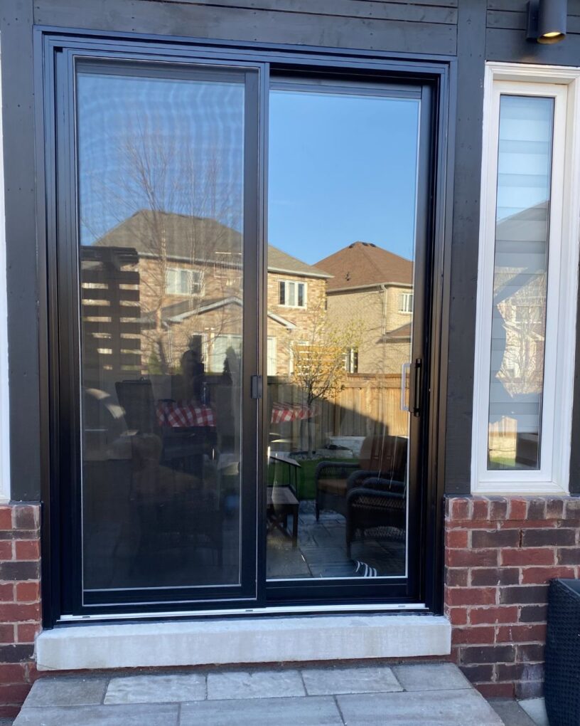 Modern black-framed 2 panel sliding doors in a Toronto home with a clearer backyard view