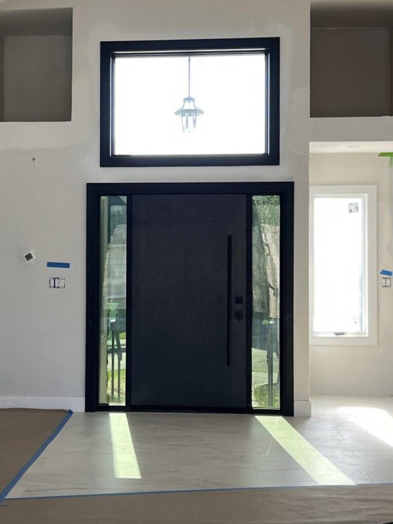 Modern fiberglass front door with narrow sidelights and clean lines in a Massachusetts home.