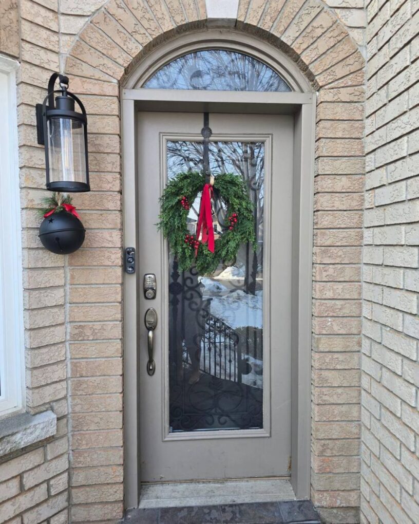 Before and after view of an arched front door replacement on a brick home in Oakville