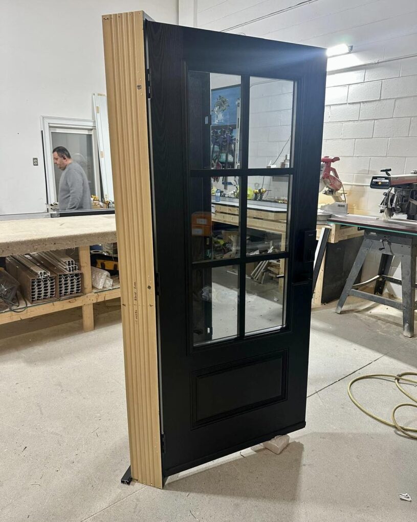 Custom black fiberglass door manufactured in Toronto for installation in Oakville.