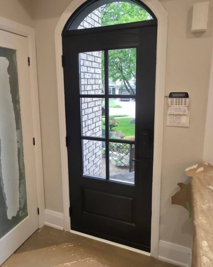 Finished interior view of the new arched fiberglass front door in Oakville, showing a brighter entry and a cleaner, more updated look