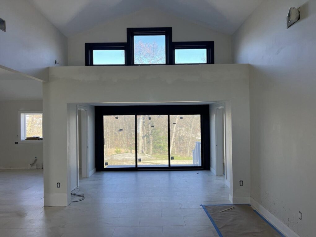 Wide three-panel sliding patio door with large glass area and clean installation in Massachusetts.