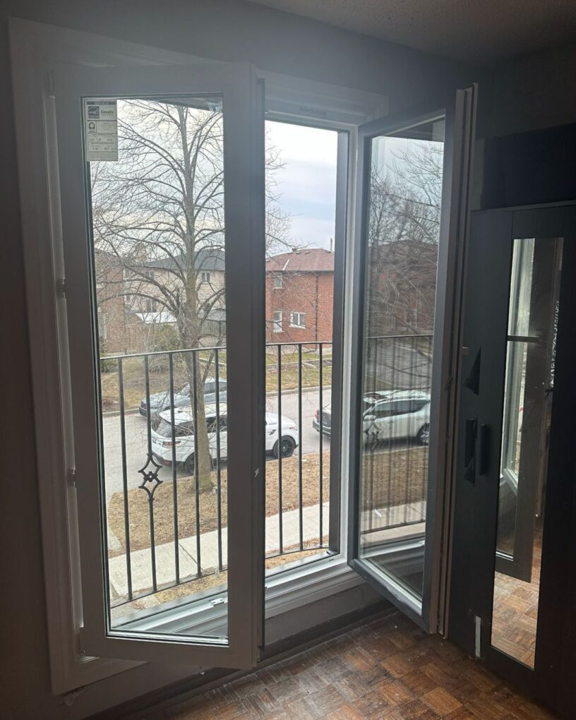 European tilt and turn doors in Maple opening to a bright backyard patio with a clean modern frame design.