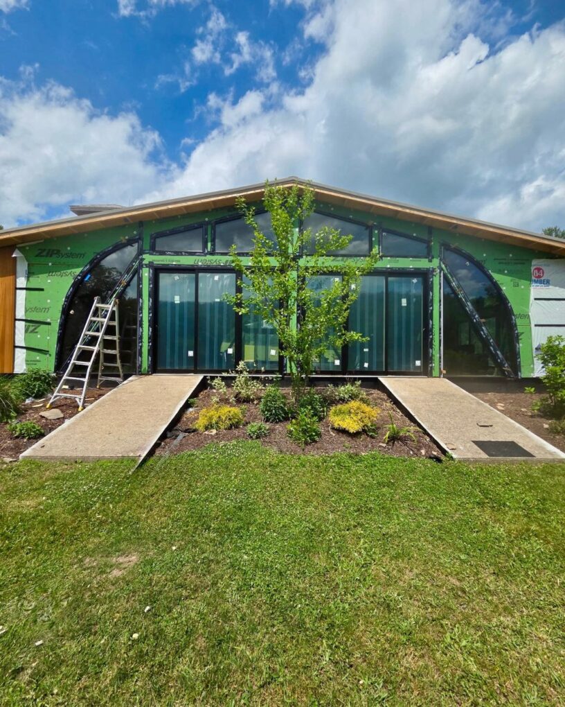 Exterior view of custom shaped windows and stacked sliding doors on the Moonrise Valley building.