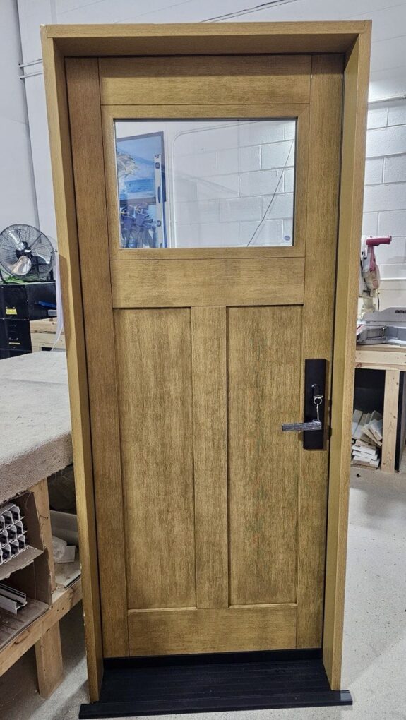 Custom fiberglass entry door with glass insert and stained woodgrain finish