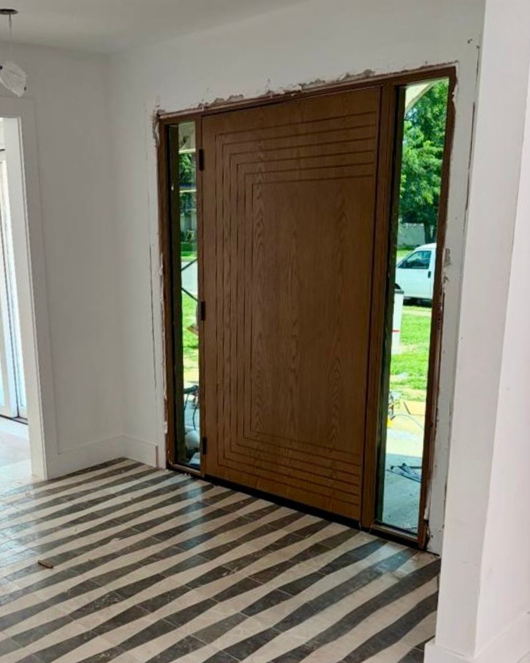 Fiberglass wood grain front door with sidelights installed in a New Jersey home