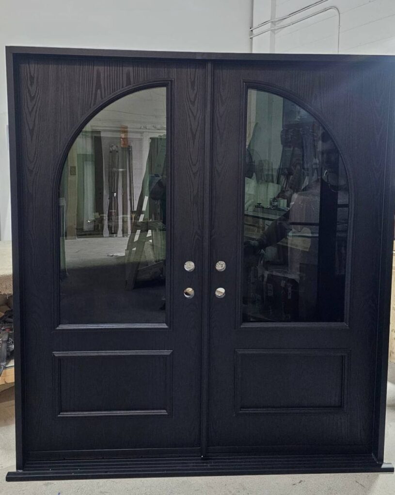 Fiberglass double entry doors with curved grey glass and dark woodgrain finish