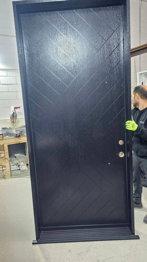 Modern black fiberglass entry door with textured woodgrain finish